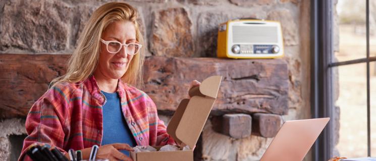 Woman packs goods in a parcel