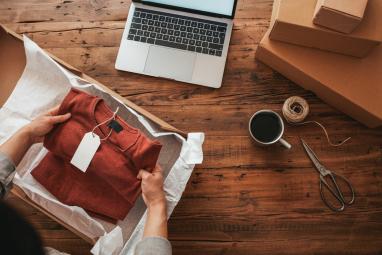 Man takes a sweater out of a package