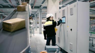 Employees look at a screen