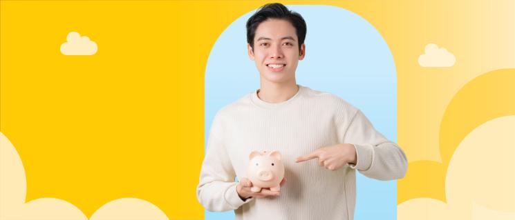 Man holding a piggy bank and thinking.