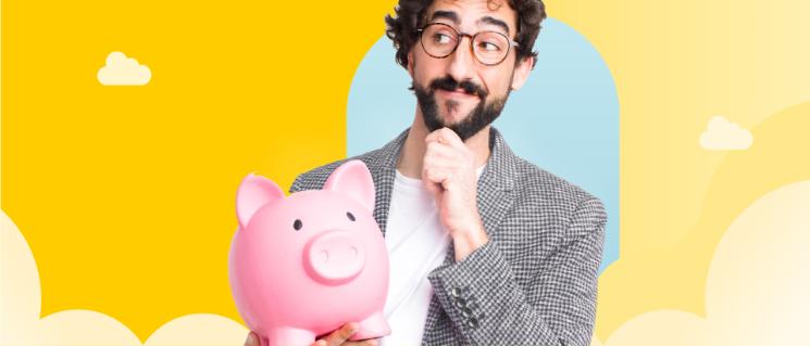 Man holding a piggy bank and thinking.