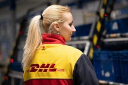 A DHL employee facing backwards inside the warehouse.