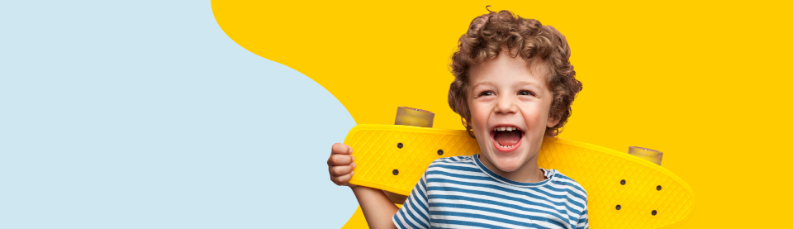 Happy child holding skateboard.