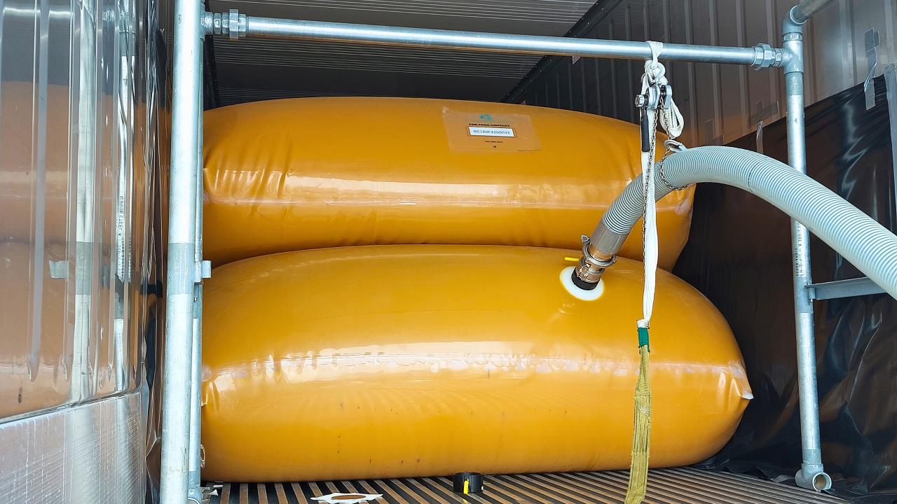 Flexitank inside an ocean reefer container with hose plugged into it